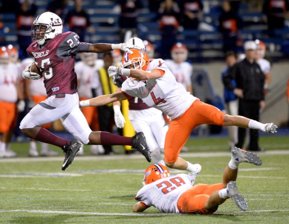 Lee wide receiver Jordan Trimble (25) rockets past a tackle by San Angelo Central cornerback Will Vincent (4) and safety Beau Lasater (28) on Friday, Oct. 30, 2015, at Grande Communications Stadium. James Durbin/Reporter-Telegram